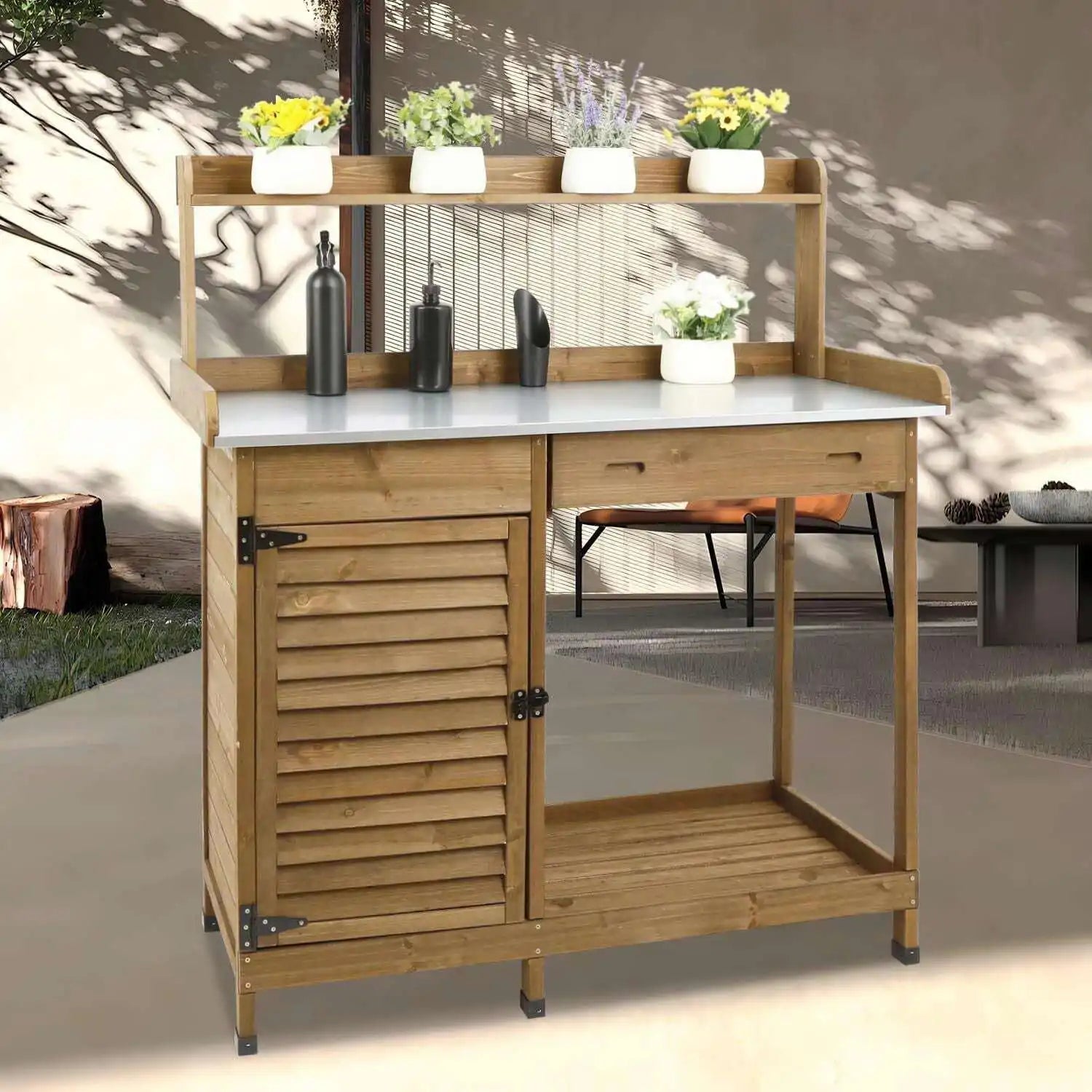 Outdoor wooden potting bench with metal tabletop in garden setting